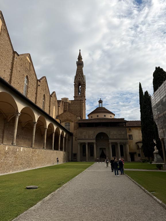 Courtyard with brown buildings in background.