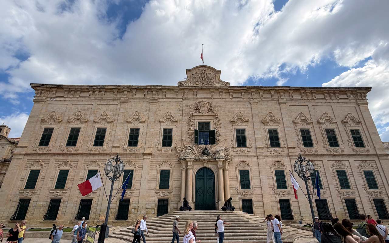 Malta Castille Palace People walking in front of the Auberge de Castille Palace. Outside in Valletta