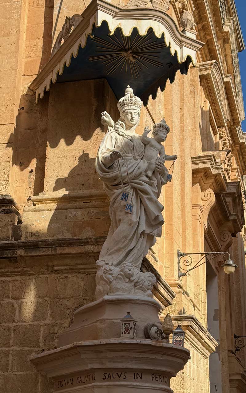 Mdina Statue Female Mdina Statue at the Annunciation Church. She is holding a baby.
