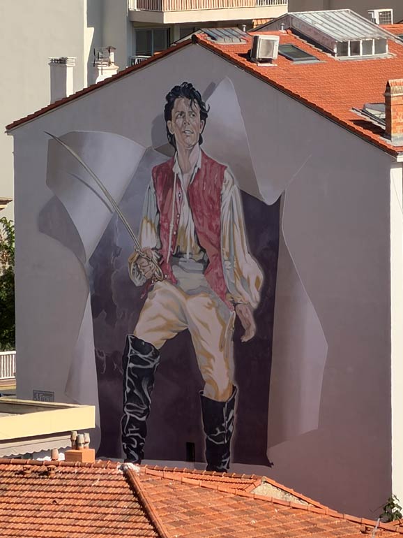 Film Mural A large painted pirate man film mural on the side of a building.