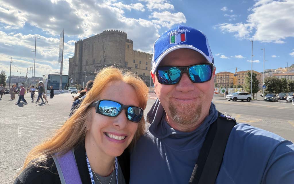 Naples Selfie Anna and Gordon Selfie with Castel Nuovo in the background.