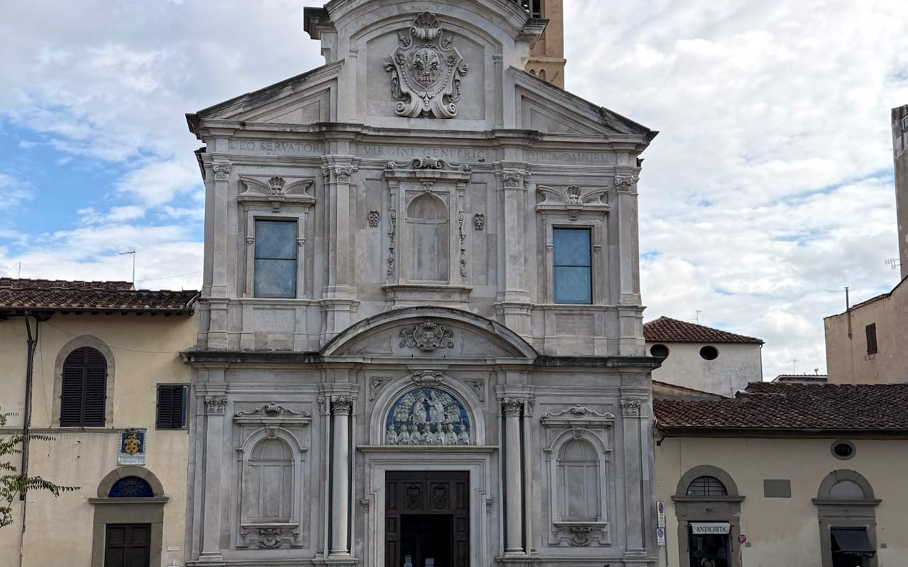 Ognissanti Church built in 1251. Gray color church with brown buildings behind it.