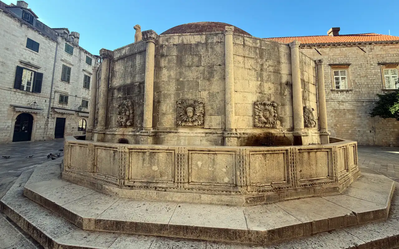 The Onofrio Fountain with carved faces on it.