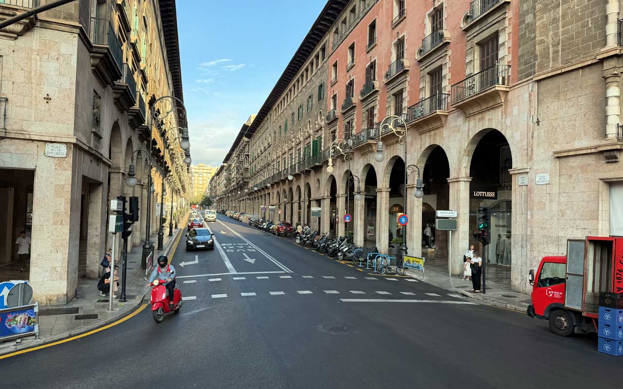 Palma de Mallorca Street in Palma de Mallorca with red moped turning.