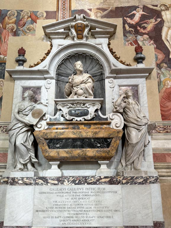 Three statues. Middle one is a man looking upwards.