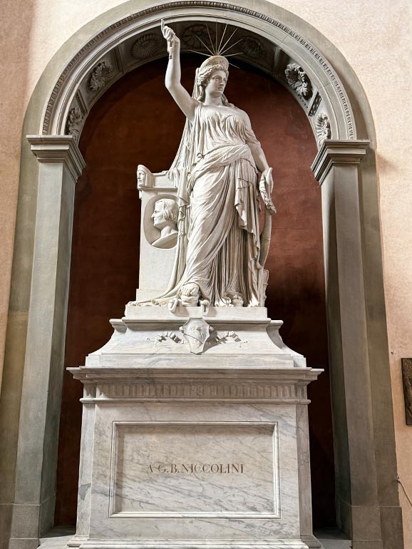 Woman statue standing with crown on head.