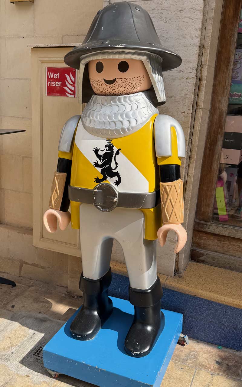 Valletta Knight Valletta Knight Toy soldier. Bucket helmet and yellow and white outfit. Lion with crown on front of shirt.