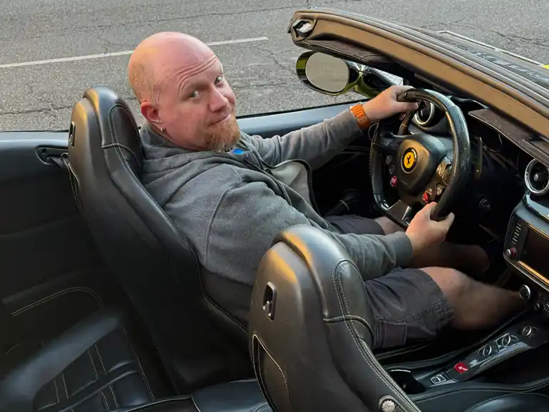Gordon sitting in a Ferrari California
