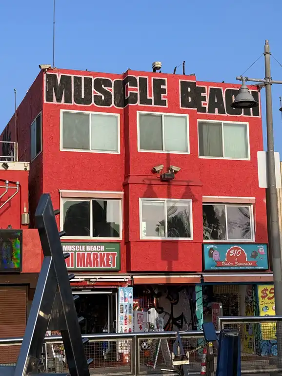 Red building that says Muscle Beach, Venice Beach, California.