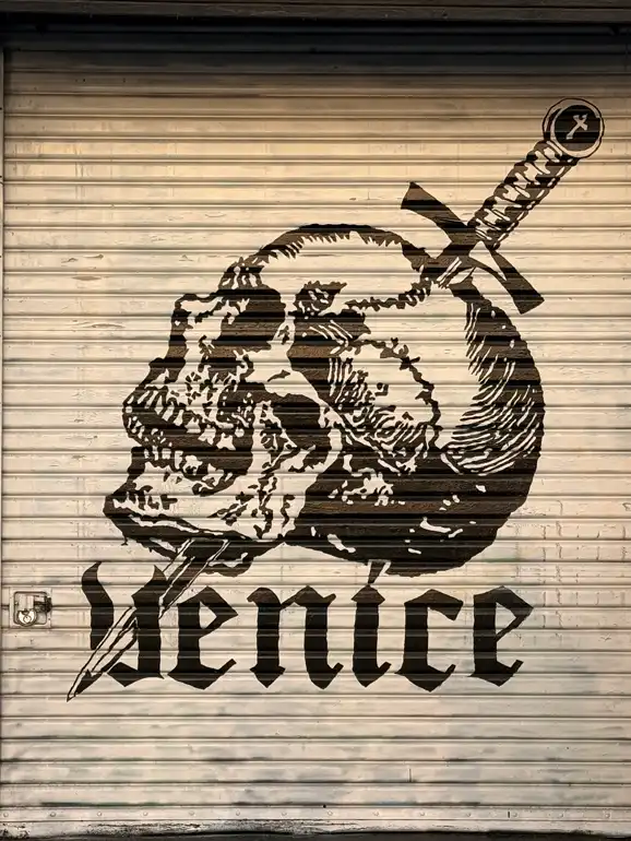 A skull mural painted on a garage door.