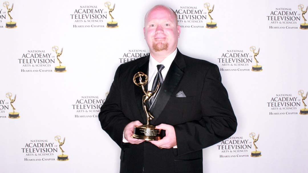 Gordon Eaton holding his Heartland Regional Emmy Award at the official awards ceremony.